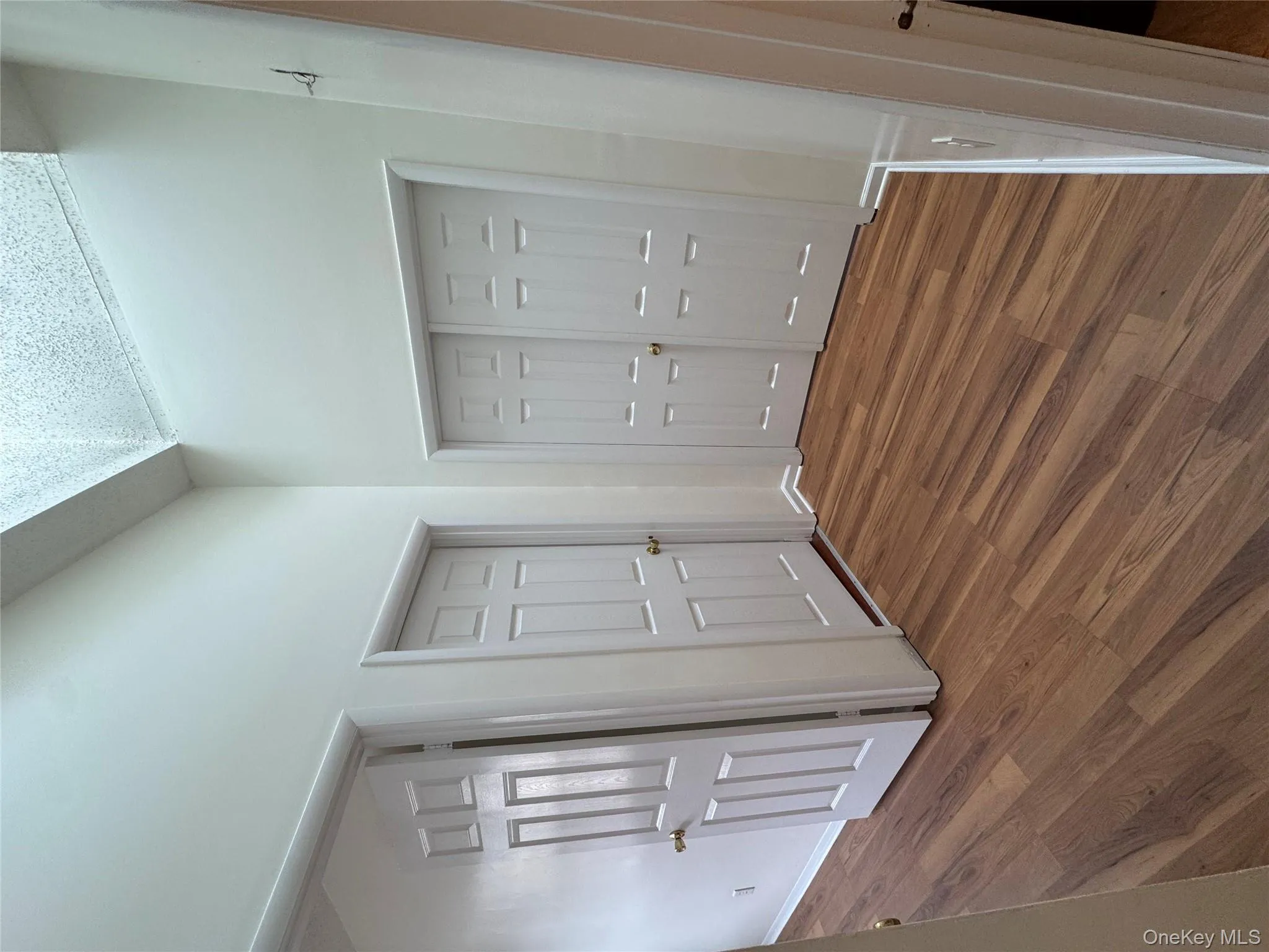 Unfurnished bedroom featuring dark wood-type flooring and a closet Unfurnished bedroom featuring dark wood-type flooring and a closet