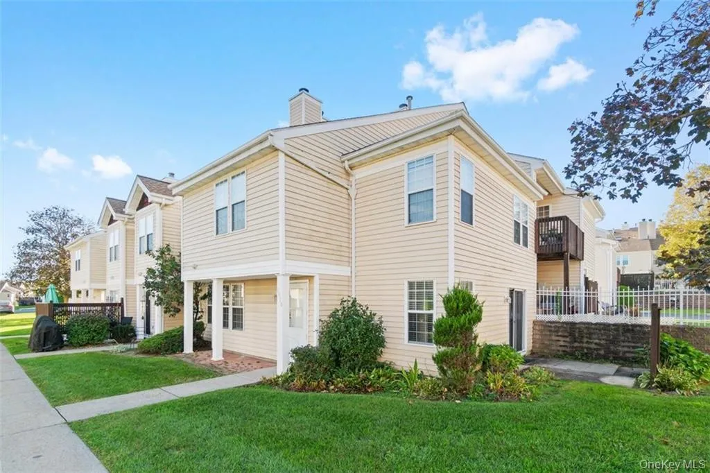 View of home's exterior with a chimney and a balcony View of home's exterior with a chimney and a balcony