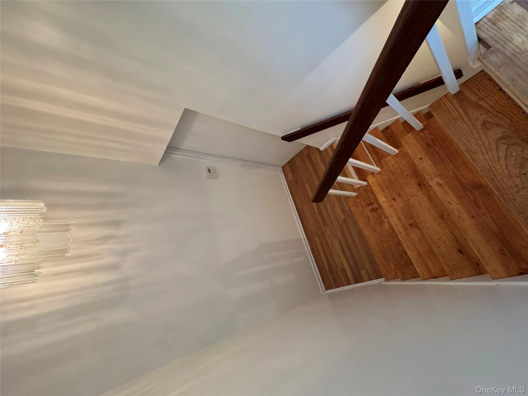 Staircase featuring wood finished floors and baseboards Staircase featuring wood finished floors and baseboards
