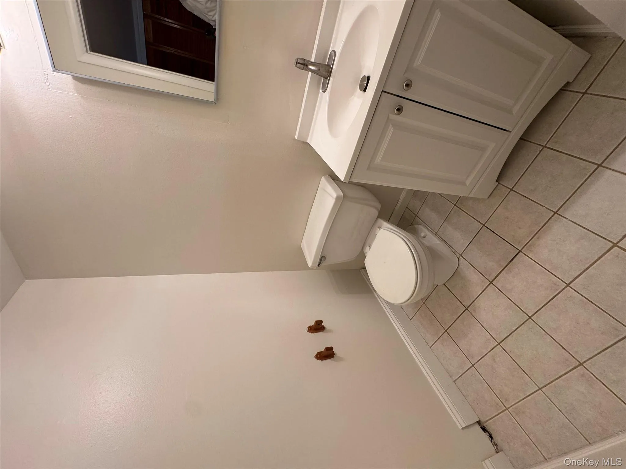 Half bath featuring light tile patterned floors and vanity Half bath featuring light tile patterned floors and vanity