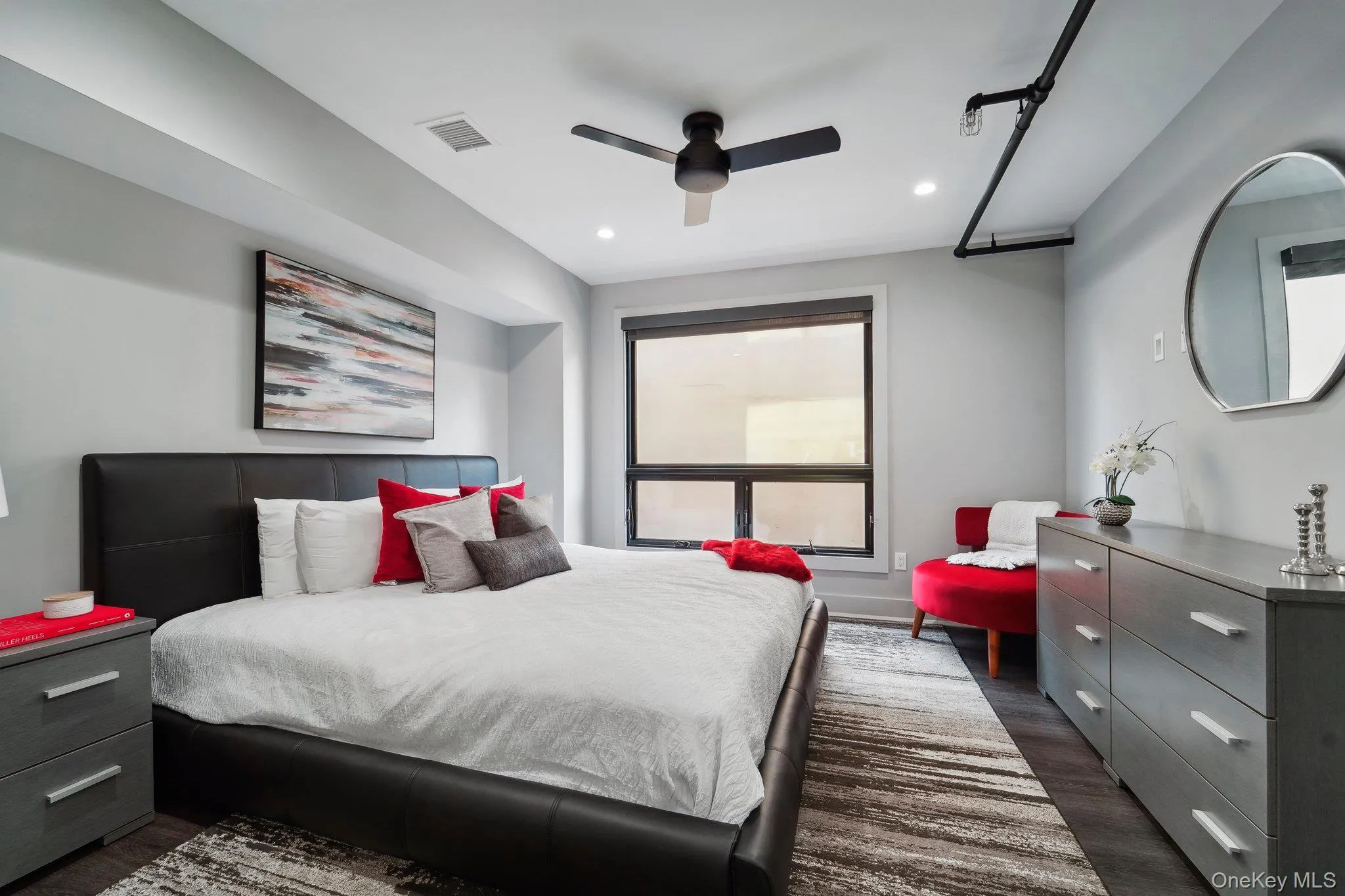 Bedroom with dark wood-type flooring, ceiling fan, and recessed lighting Bedroom with dark wood-type flooring, ceiling fan, and recessed lighting