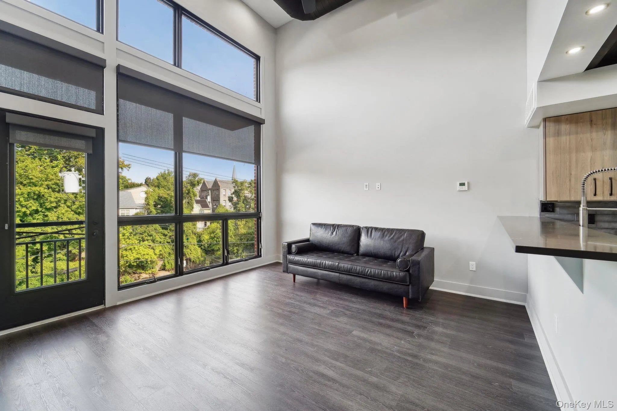 Sitting room featuring dark wood finished floors and a high ceiling Sitting room featuring dark wood finished floors and a high ceiling