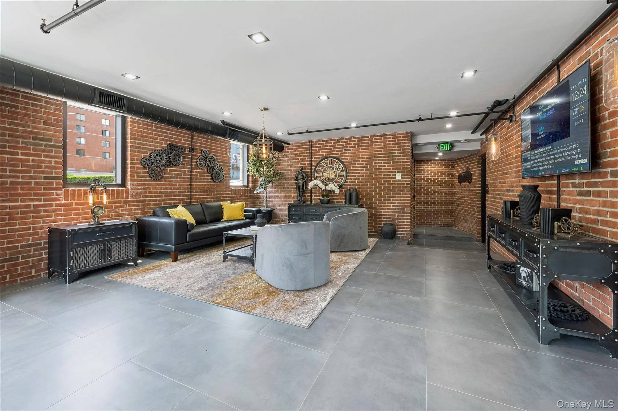 Common area featuring brick wall Common area featuring brick wall