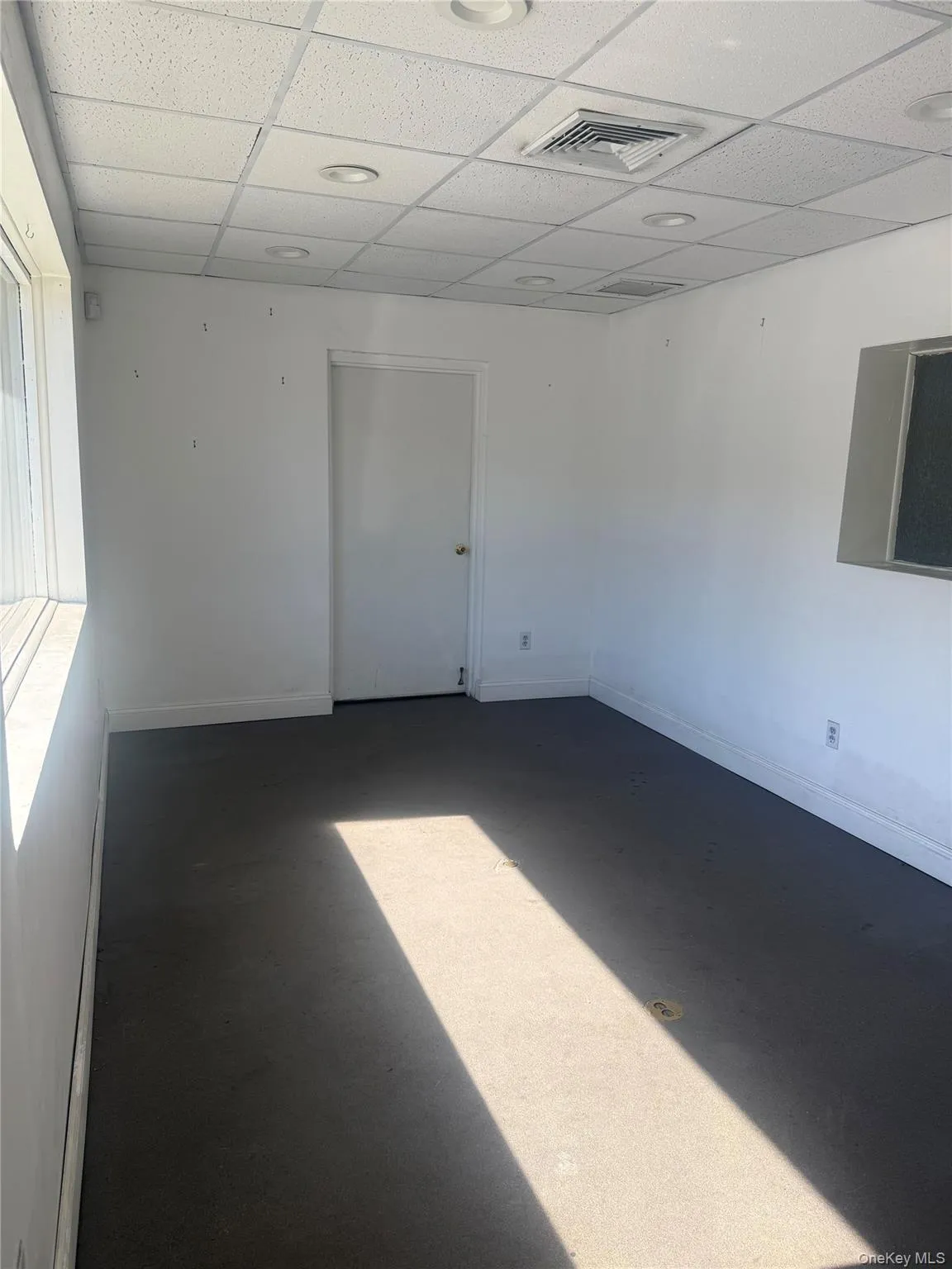 Unfurnished room featuring a paneled ceiling Unfurnished room featuring a paneled ceiling