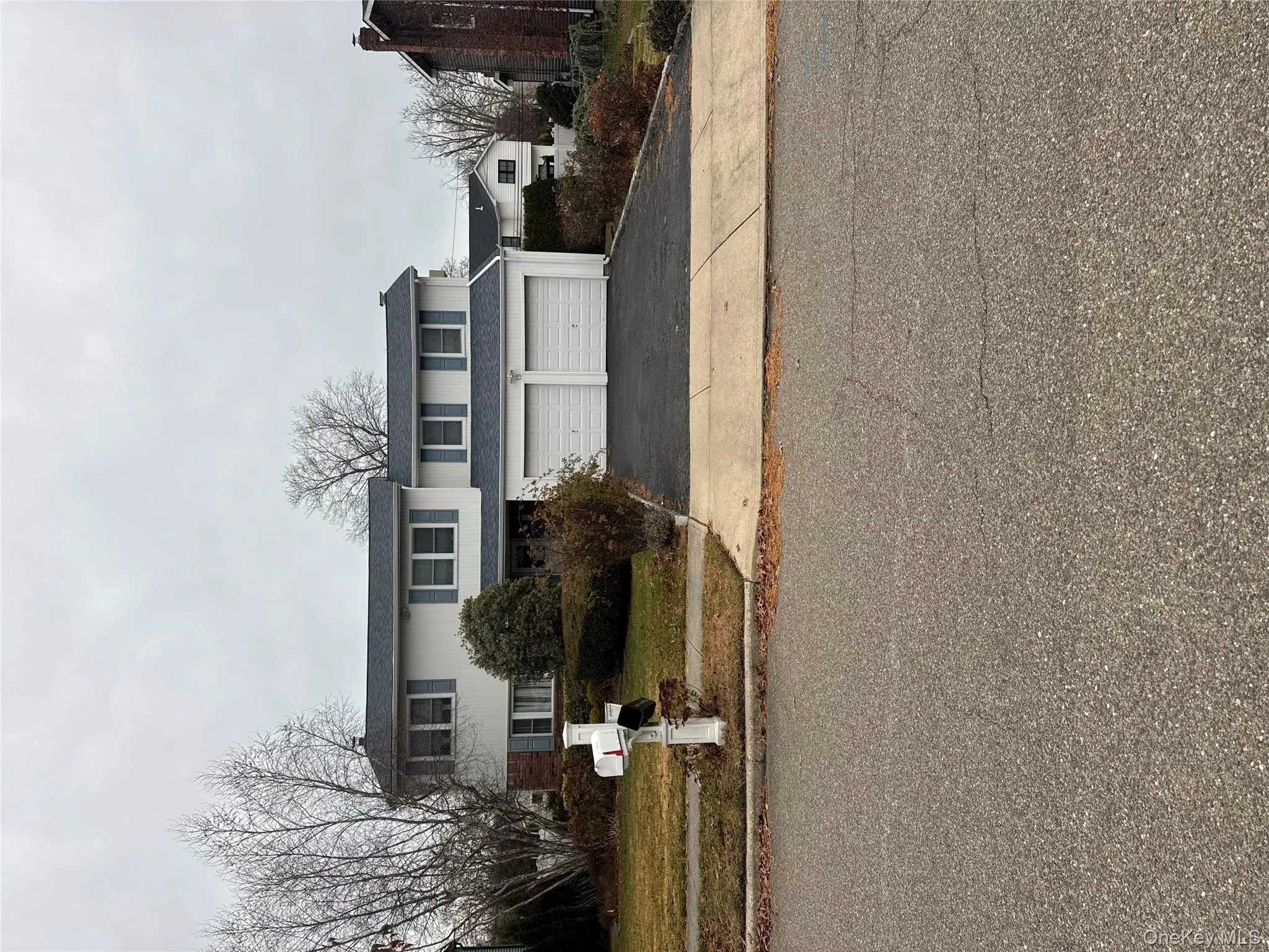 Traditional-style house with driveway and a garage Traditional-style house with driveway and a garage