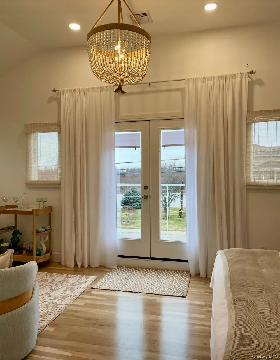 Entryway featuring french doors, wood finished floors, plenty of natural light, recessed lighting, and a chandelier Entryway featuring french doors, wood finished floors, plenty of natural light, recessed lighting, and a chandelier