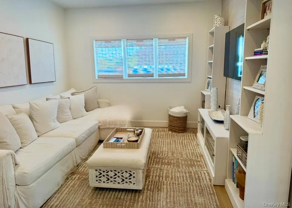 Living area featuring light wood-style floors and baseboards Living area featuring light wood-style floors and baseboards