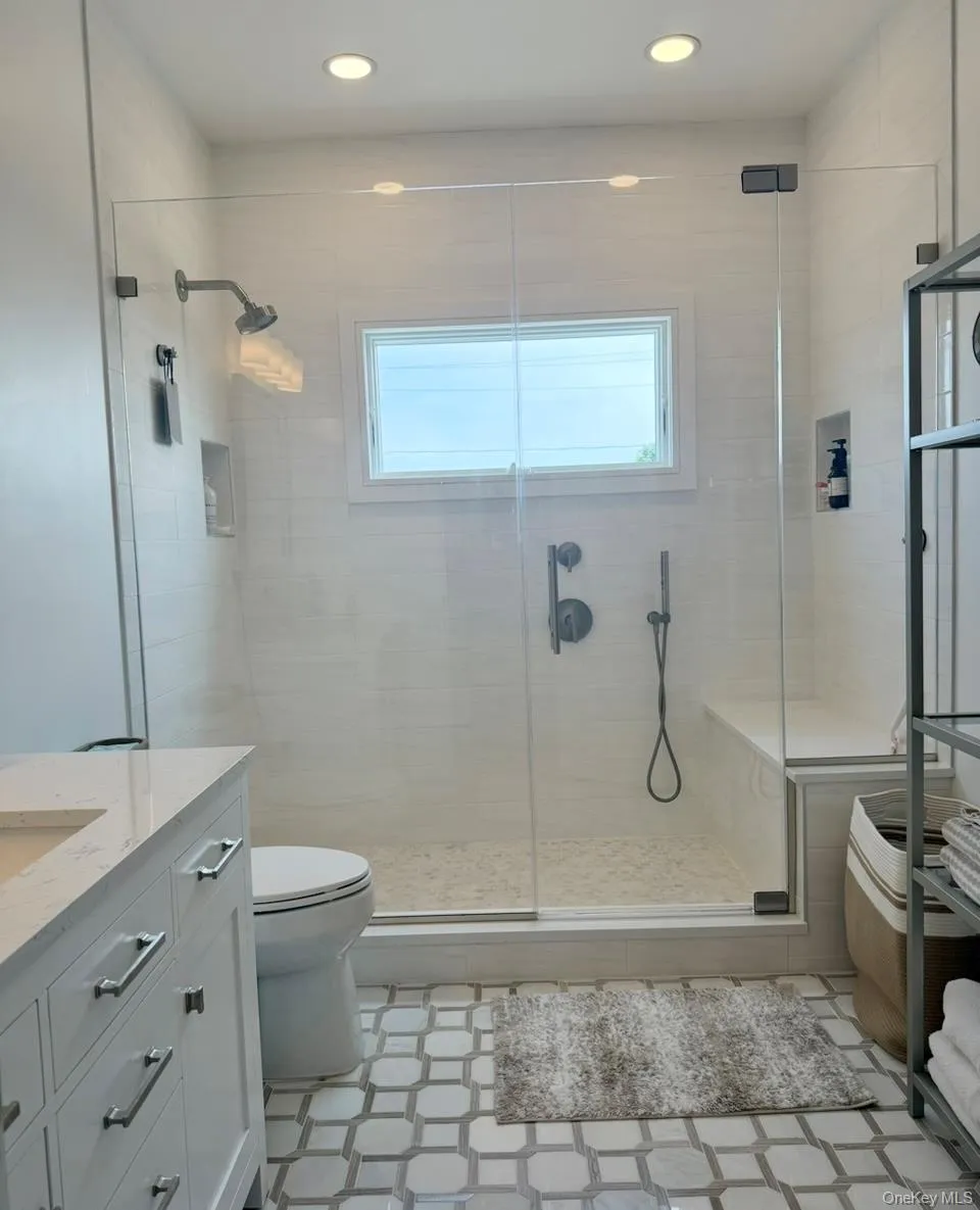 Full bathroom featuring vanity, a shower stall, and recessed lighting Full bathroom featuring vanity, a shower stall, and recessed lighting