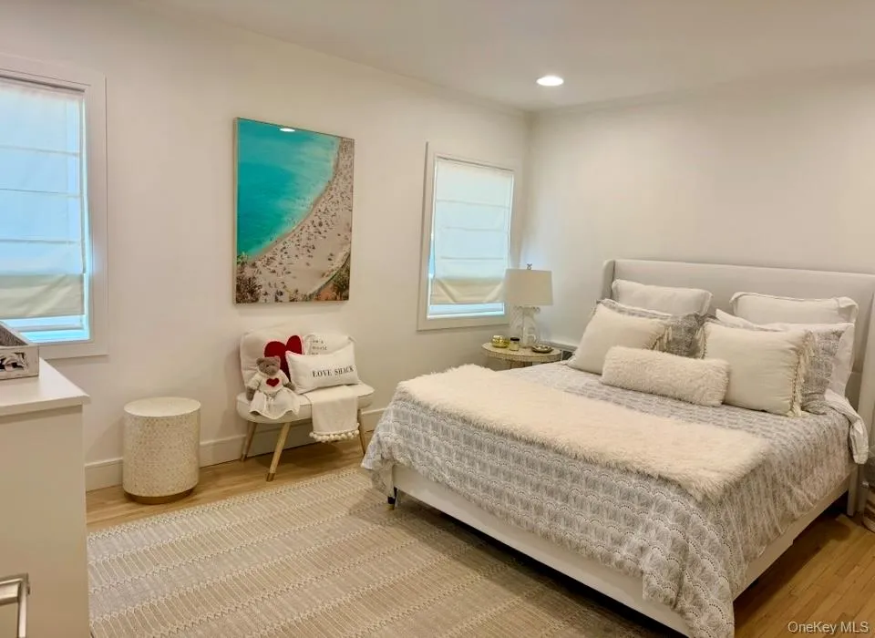 Bedroom with light wood-style flooring, recessed lighting, and crown molding Bedroom with light wood-style flooring, recessed lighting, and crown molding