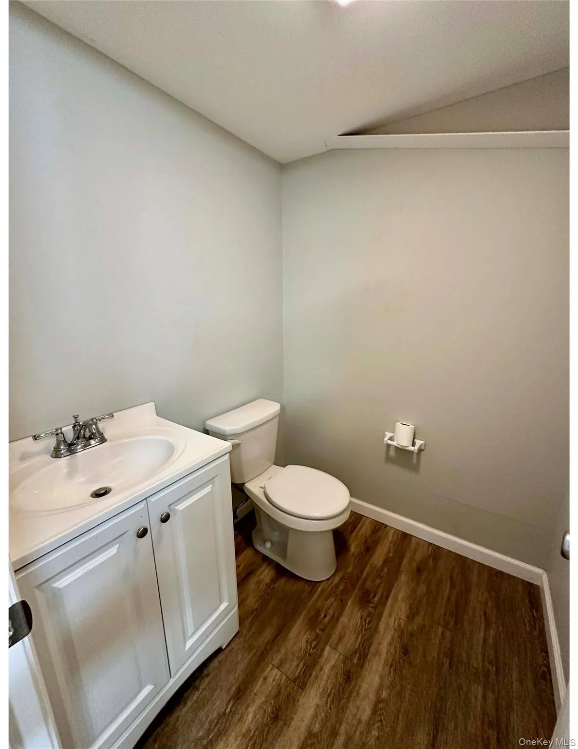 Half bath featuring dark wood finished floors and vanity Half bath featuring dark wood finished floors and vanity