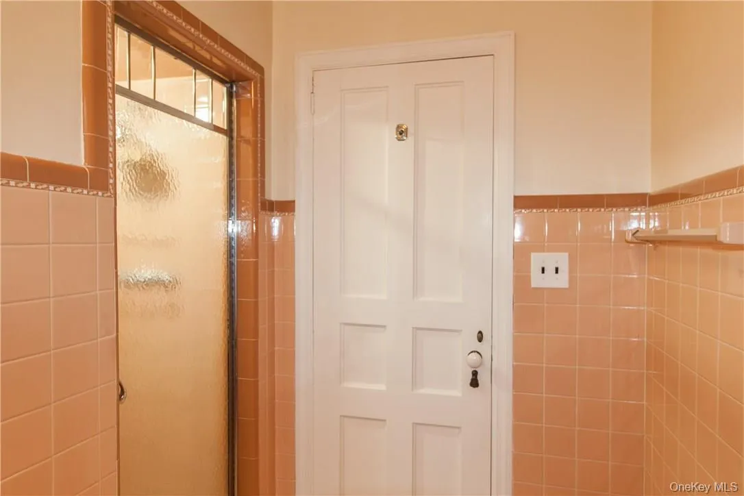 Features tub and shower stall. Features tub and shower stall.