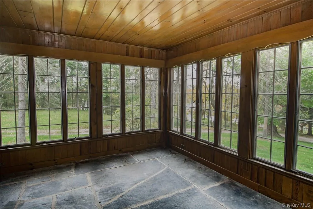 Features walls of windows, slate flooring and a brick wall. Features walls of windows, slate flooring and a brick wall.