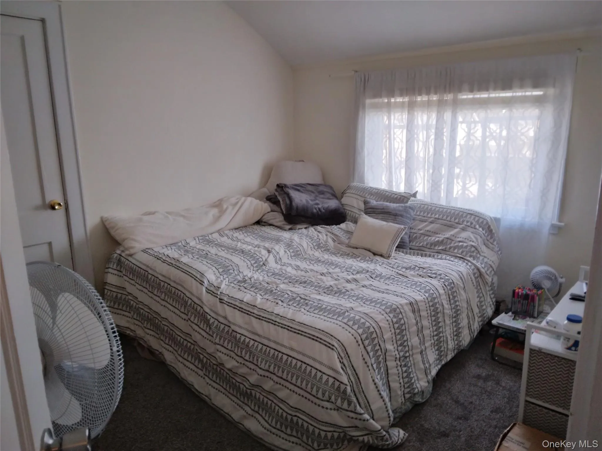 Carpeted bedroom with big window Carpeted bedroom with big window