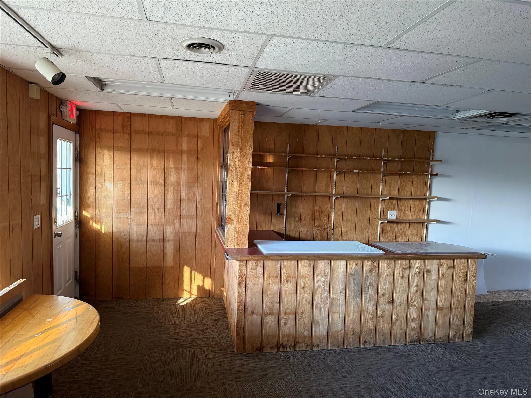 Bar with wooden walls and a paneled ceiling Bar with wooden walls and a paneled ceiling