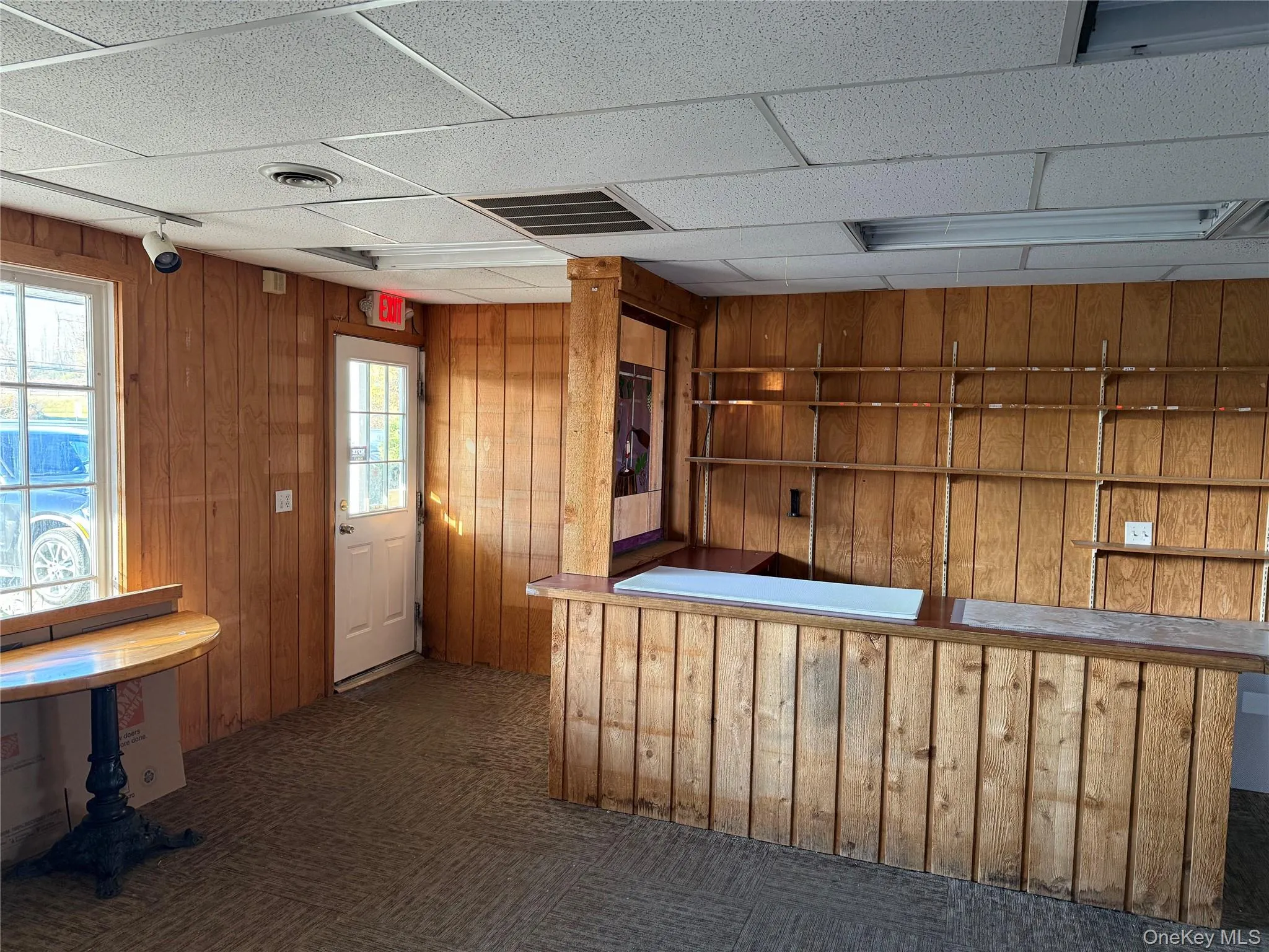 Bar area with wood walls and a drop ceiling Bar area with wood walls and a drop ceiling