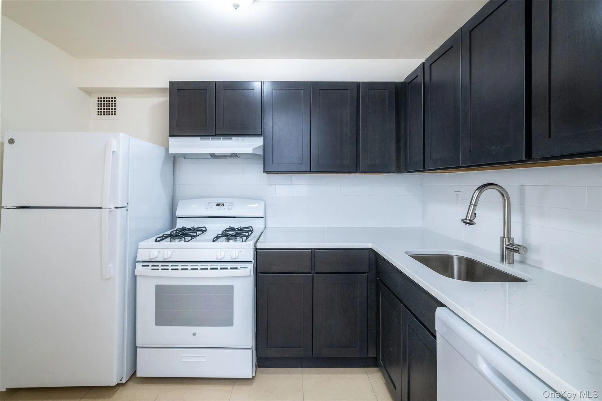 Kitchen featuring white appliances, cabinet/countertop finishes may vary from photo Kitchen featuring white appliances, cabinet/countertop finishes may vary from photo