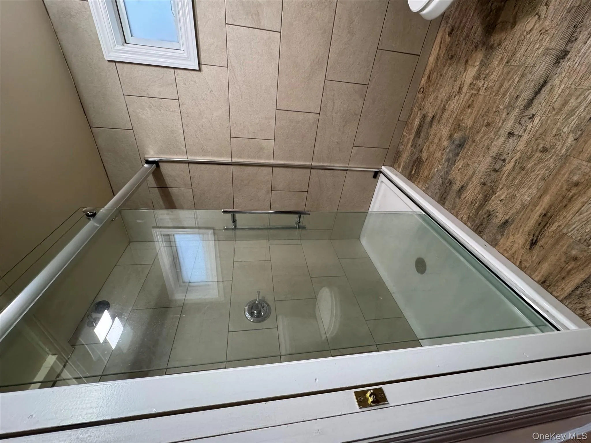 Bathroom featuring a stall shower and dark wood-type flooring Bathroom featuring a stall shower and dark wood-type flooring