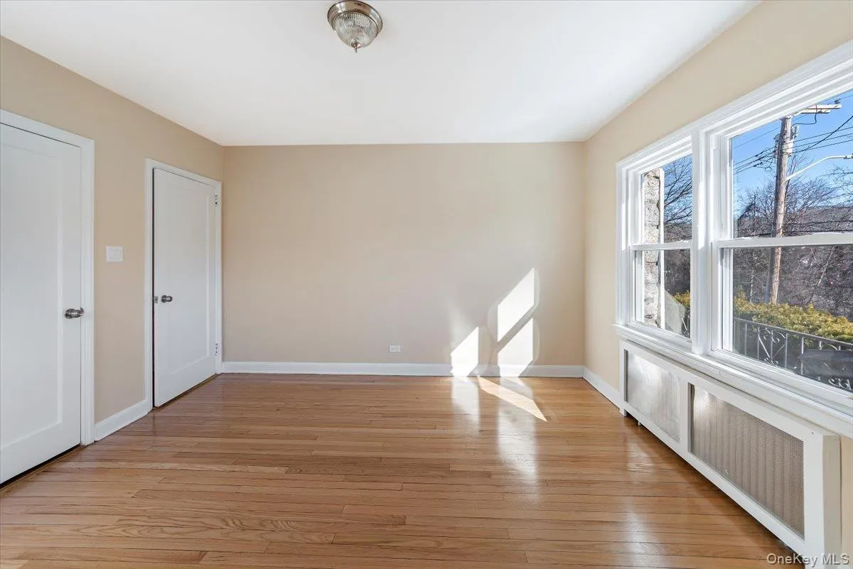 Unfurnished room featuring light wood-type flooring and baseboards Unfurnished room featuring light wood-type flooring and baseboards