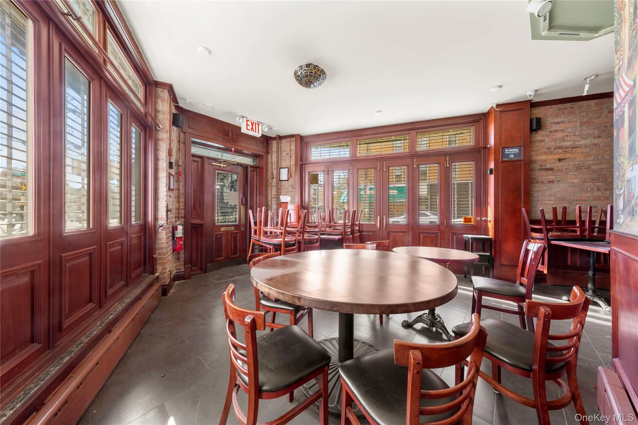 Dining area featuring plenty of natural light and brick wall Dining area featuring plenty of natural light and brick wall
