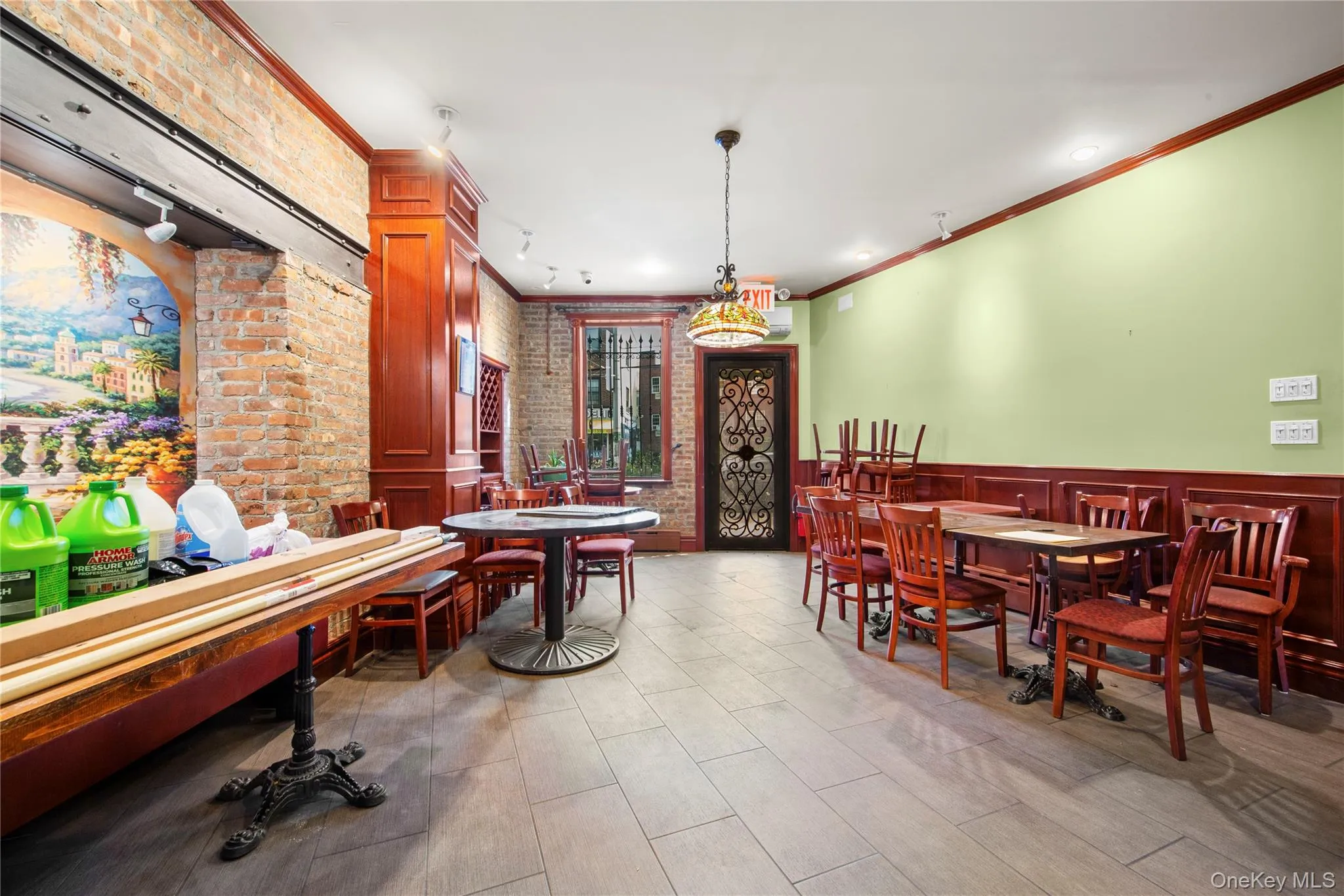 Dining area featuring brick wall and ornamental molding Dining area featuring brick wall and ornamental molding