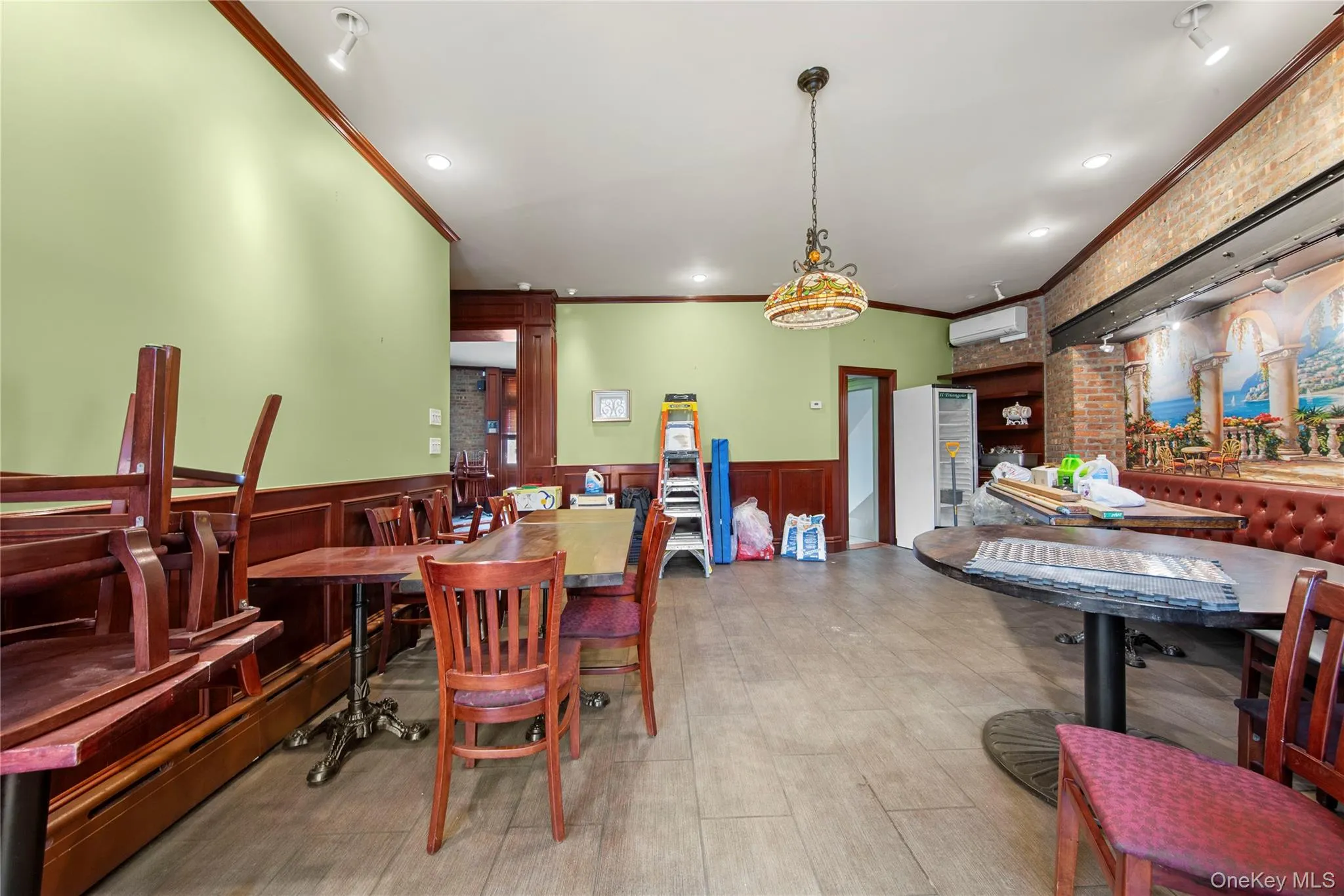 Dining area featuring crown molding, wainscoting, and a wall unit AC Dining area featuring crown molding, wainscoting, and a wall unit AC