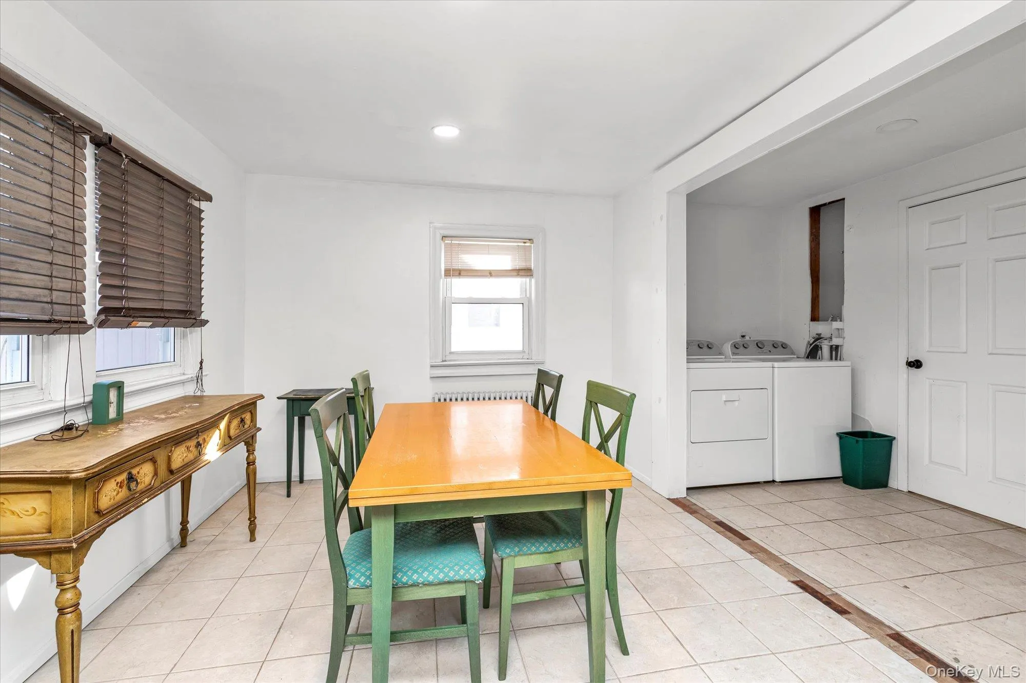 Dining area featuring light tile patterned floors, washing machine and dryer, and recessed lighting Dining area featuring light tile patterned floors, washing machine and dryer, and recessed lighting