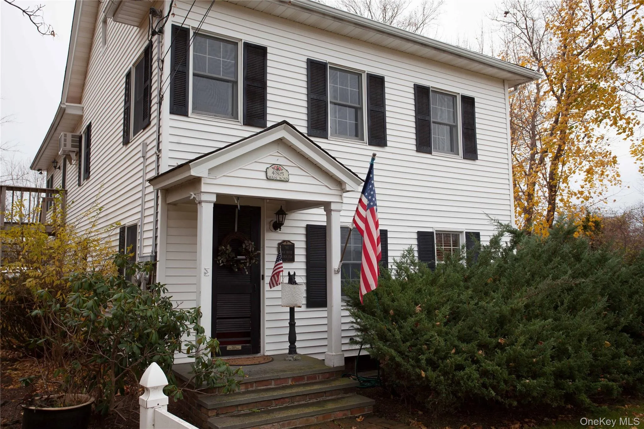 View of front facade with a wall mounted air conditioner View of front facade with a wall mounted air conditioner