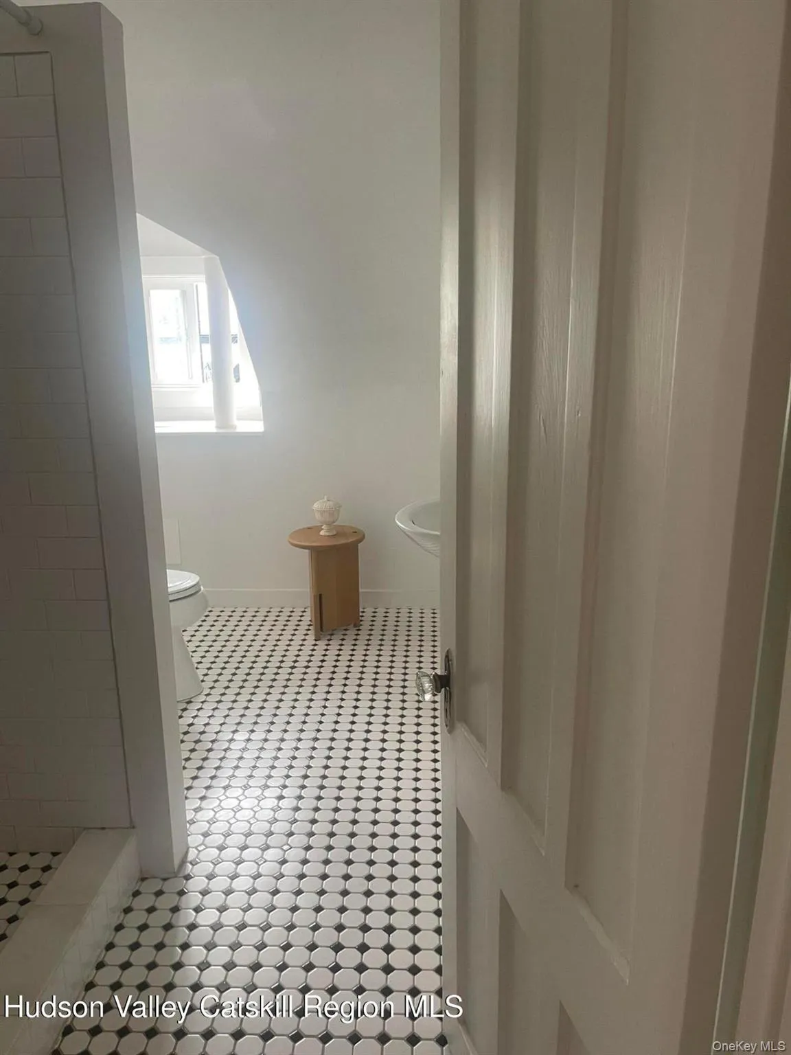 Full bathroom with tile patterned floors and tiled shower Full bathroom with tile patterned floors and tiled shower