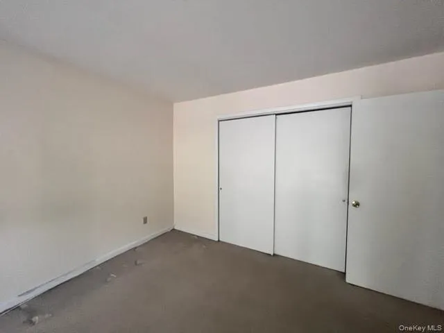 Unfurnished bedroom featuring a large closet Unfurnished bedroom featuring a large closet