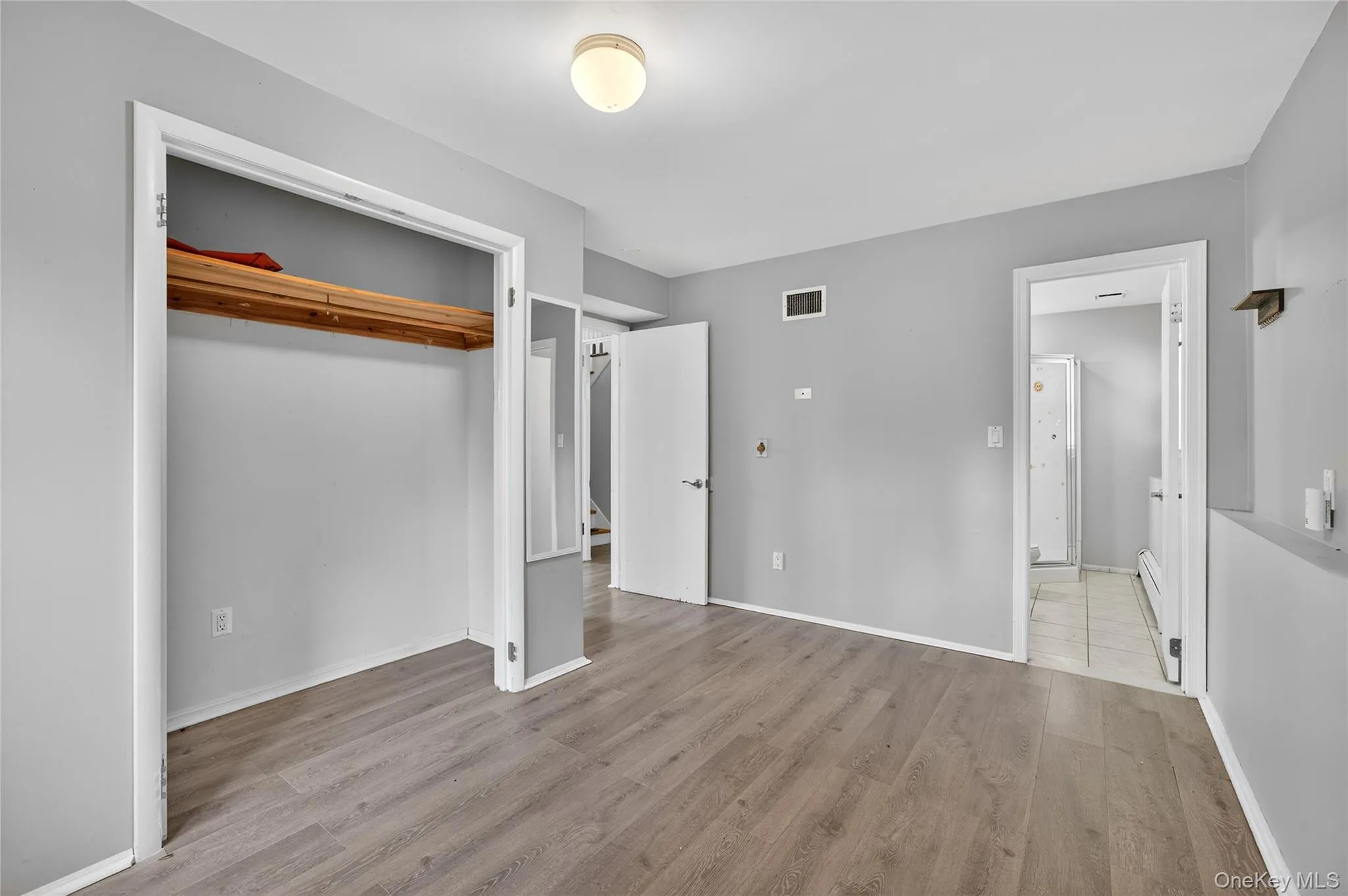 Unfurnished bedroom featuring light wood-style floors and a closet Unfurnished bedroom featuring light wood-style floors and a closet