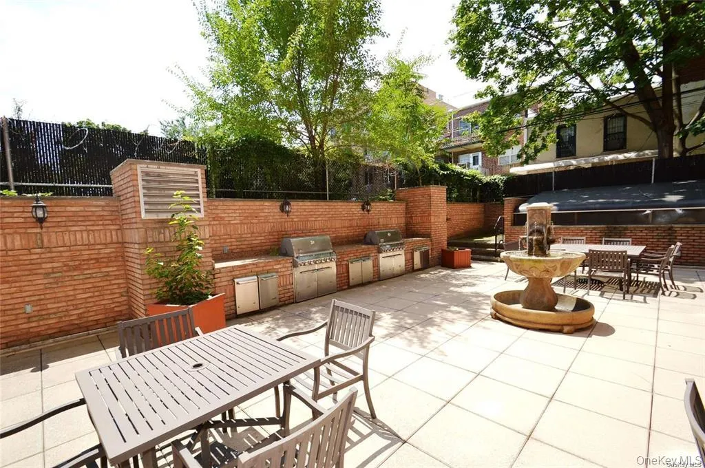 Fenced backyard featuring outdoor dining space, exterior kitchen, and a patio area Fenced backyard featuring outdoor dining space, exterior kitchen, and a patio area