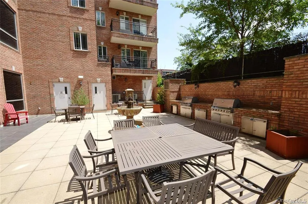 View of patio featuring outdoor dining area and exterior kitchen View of patio featuring outdoor dining area and exterior kitchen