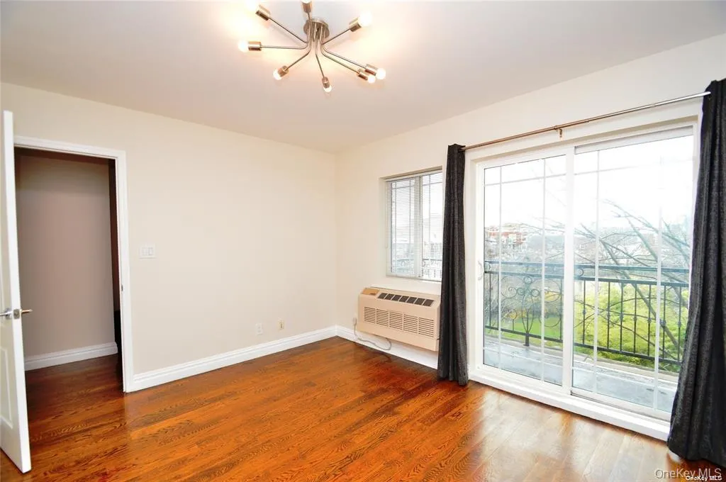 Unfurnished room featuring dark wood-style flooring and a chandelier Unfurnished room featuring dark wood-style flooring and a chandelier
