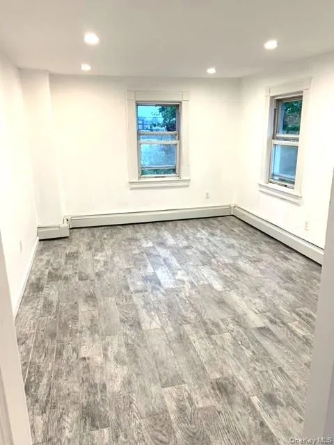 Unfurnished room featuring recessed lighting and wood finished floors Unfurnished room featuring recessed lighting and wood finished floors