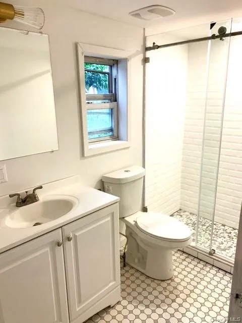Full bathroom featuring vanity and a stall shower Full bathroom featuring vanity and a stall shower