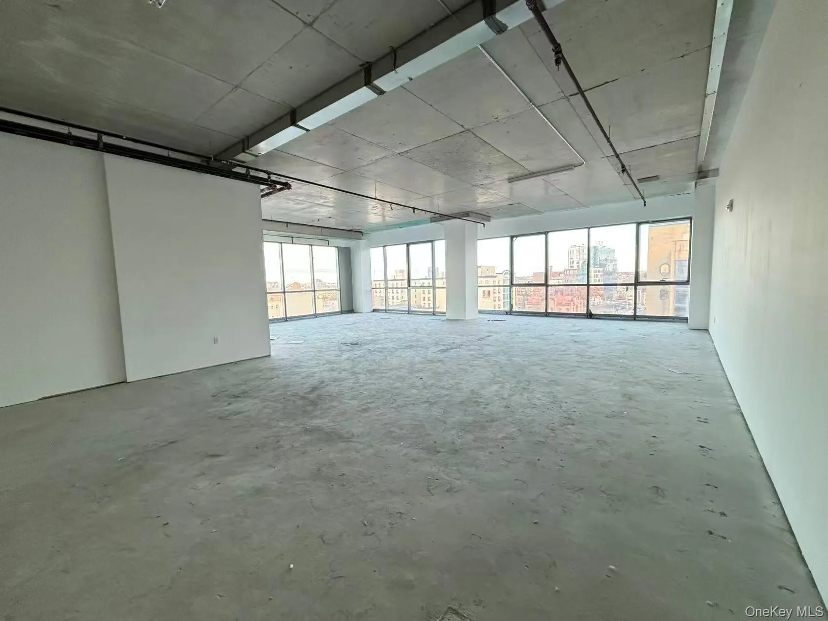 Spare room featuring concrete flooring Spare room featuring concrete flooring