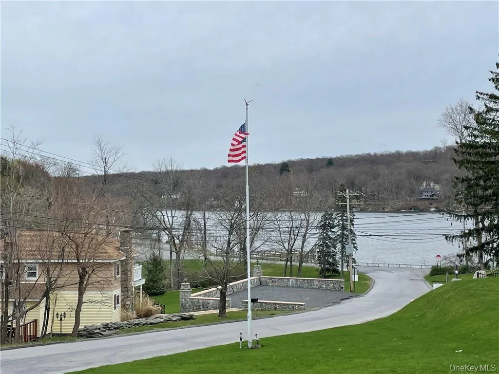 View of property's community with a water view and a yard View of property's community with a water view and a yard