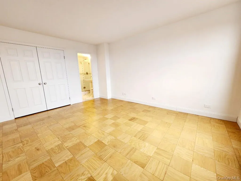 Unfurnished bedroom with a closet and connected bathroom Unfurnished bedroom with a closet and connected bathroom