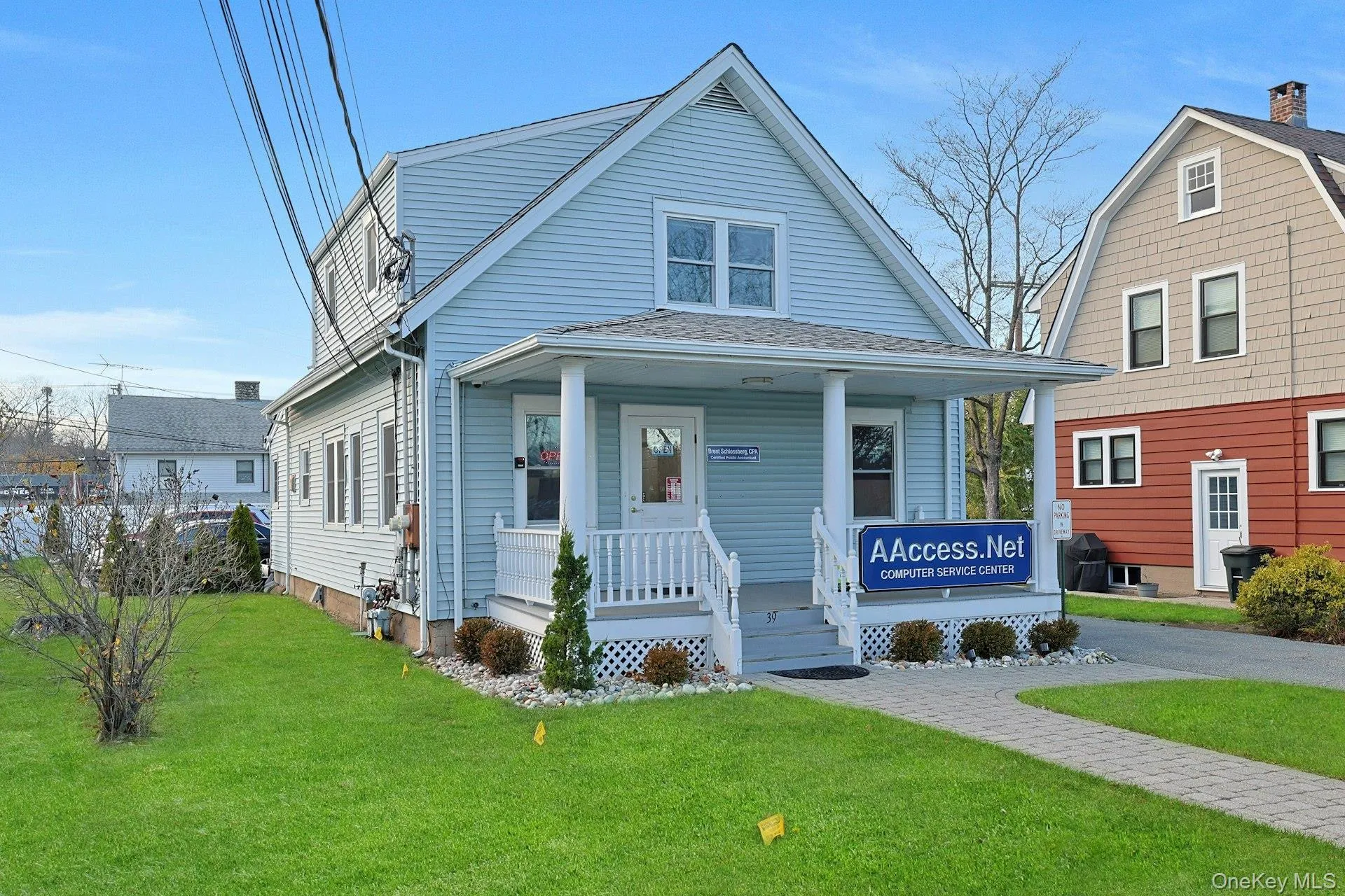 Dutch colonial featuring a porch, a front lawn, and a shingled roof Dutch colonial featuring a porch, a front lawn, and a shingled roof