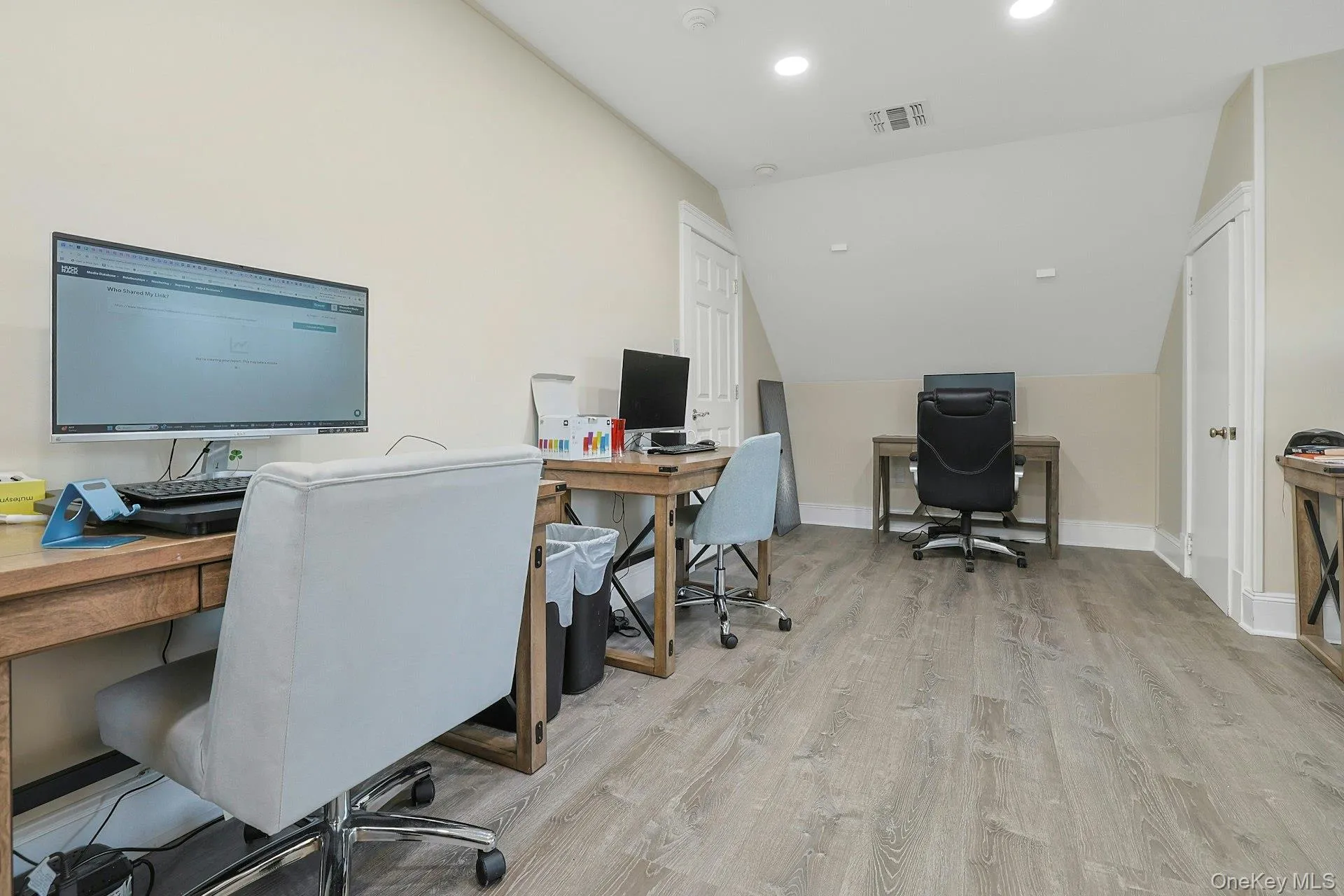 Office area with light wood-style floors, recessed lighting, and lofted ceiling Office area with light wood-style floors, recessed lighting, and lofted ceiling
