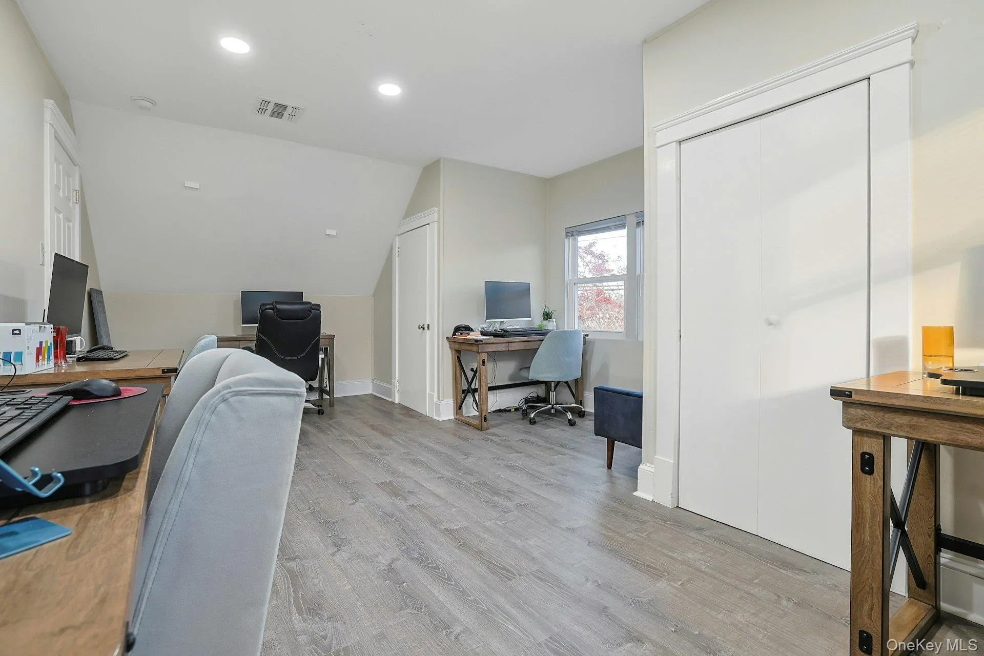 Office featuring light wood finished floors, recessed lighting, and vaulted ceiling Office featuring light wood finished floors, recessed lighting, and vaulted ceiling