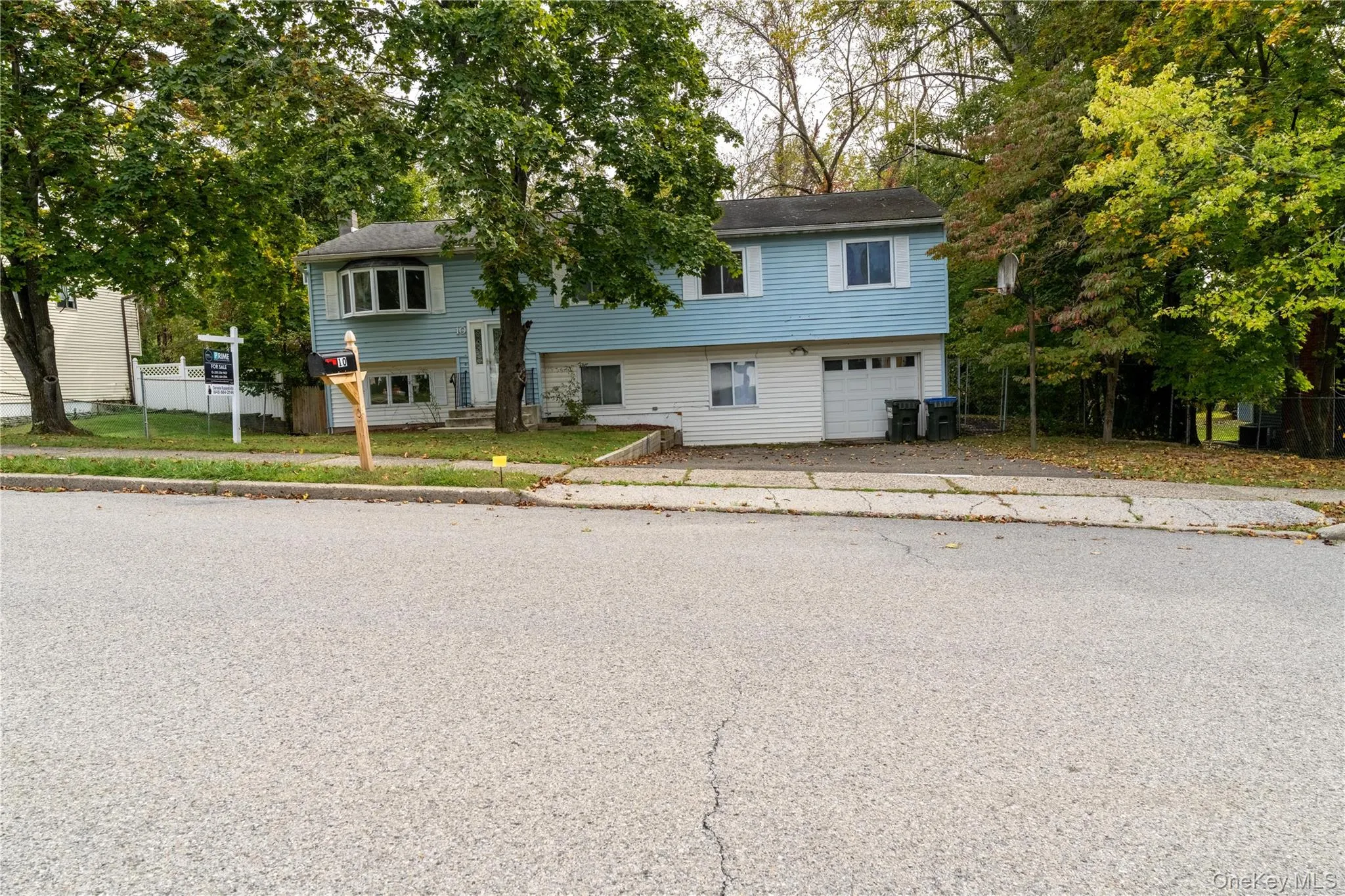 Bi-level home with an attached garage and driveway Bi-level home with an attached garage and driveway