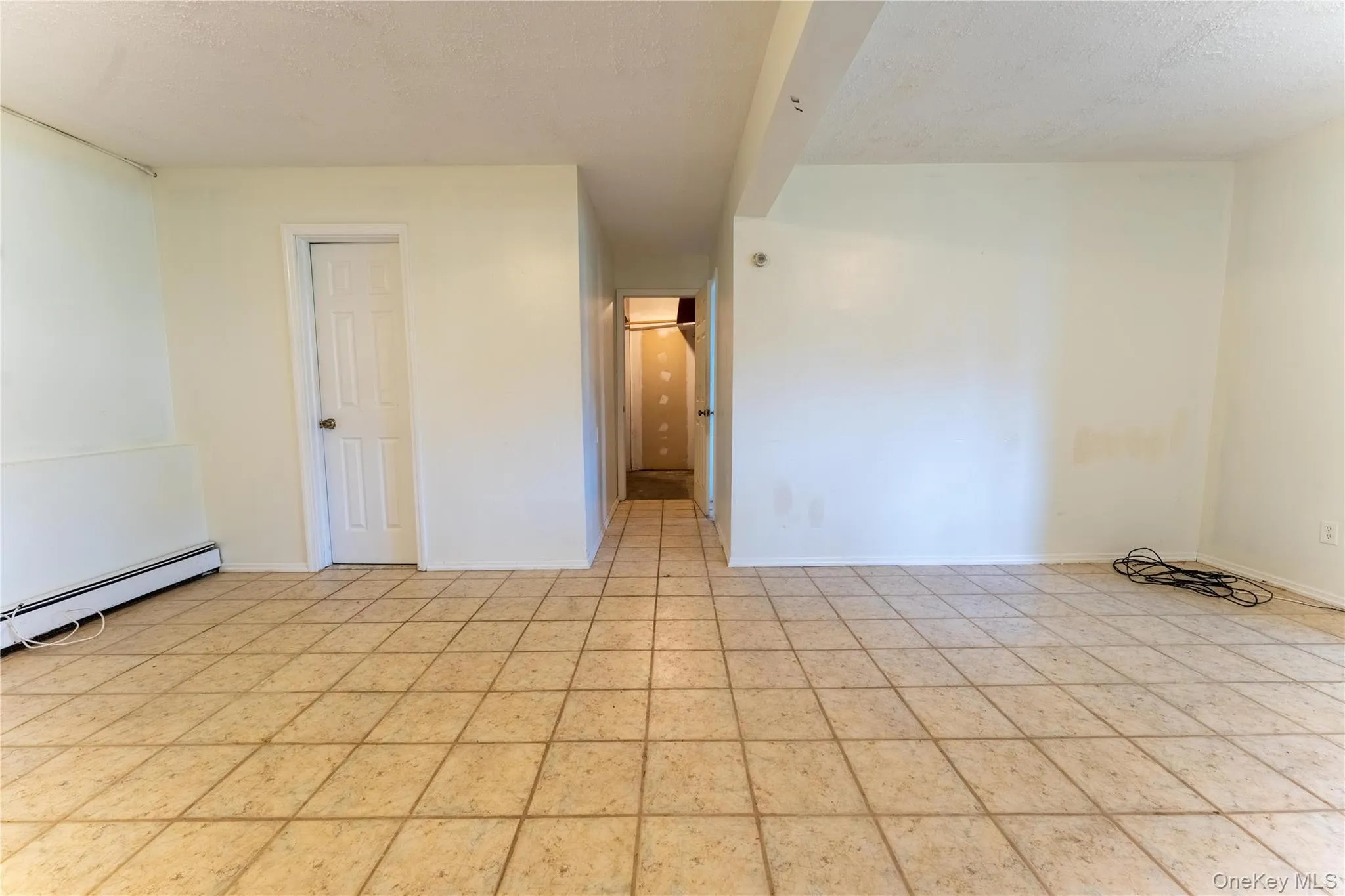 Empty room featuring a textured ceiling and baseboards Empty room featuring a textured ceiling and baseboards