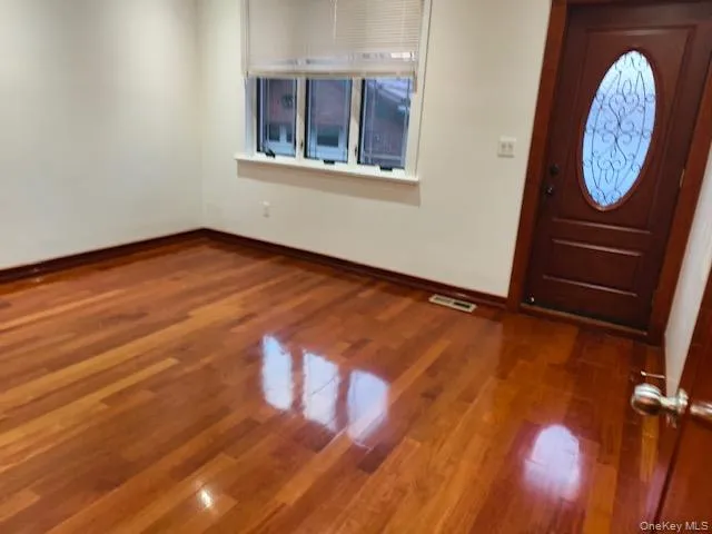 Entryway featuring dark wood-style floors and baseboards Entryway featuring dark wood-style floors and baseboards