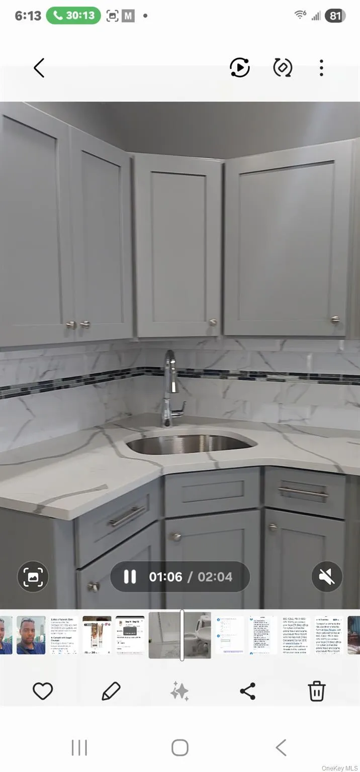 Kitchen with gray cabinets and light stone counters Kitchen with gray cabinets and light stone counters