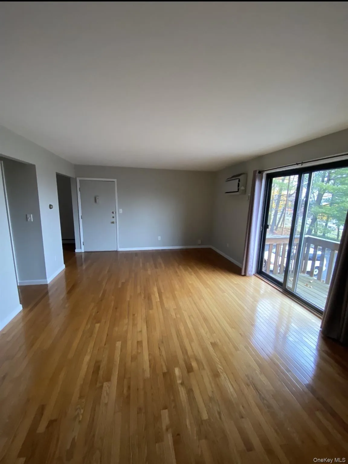 Empty room featuring wood finished floors and baseboards Empty room featuring wood finished floors and baseboards