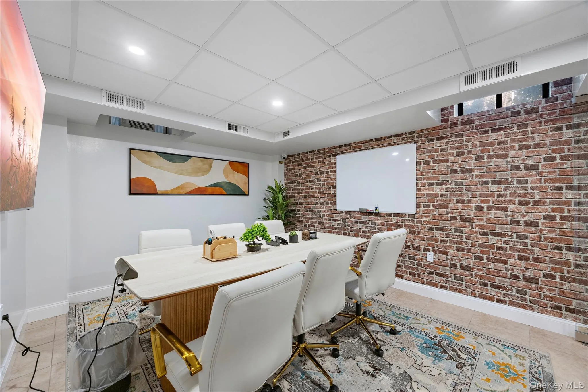 Tiled dining area with brick wall, an accent wall, a paneled ceiling, and recessed lighting Tiled dining area with brick wall, an accent wall, a paneled ceiling, and recessed lighting