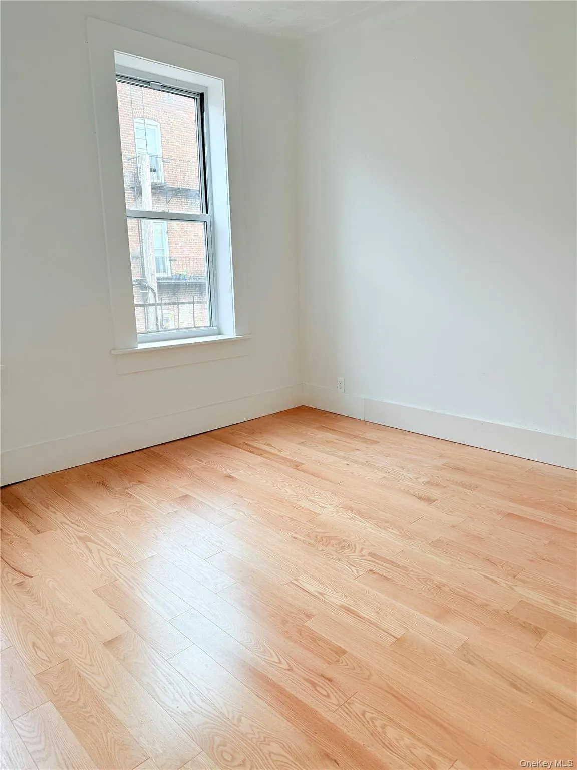 Unfurnished room featuring light wood finished floors and baseboards Unfurnished room featuring light wood finished floors and baseboards