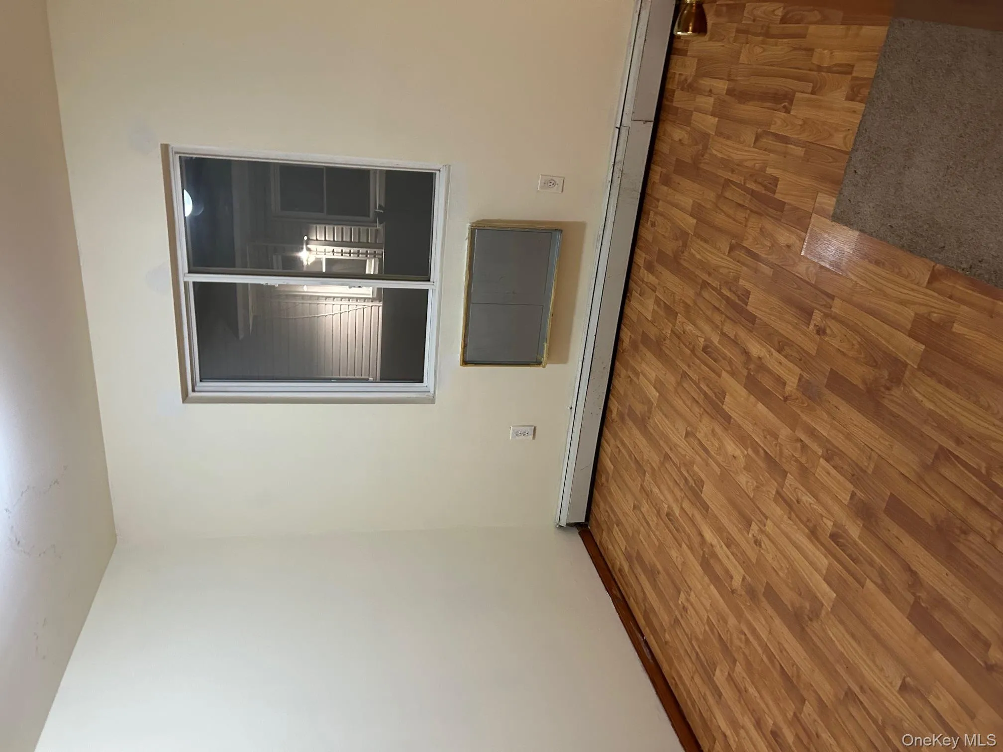 Spare room featuring wood finished floors and a baseboard heating unit Spare room featuring wood finished floors and a baseboard heating unit