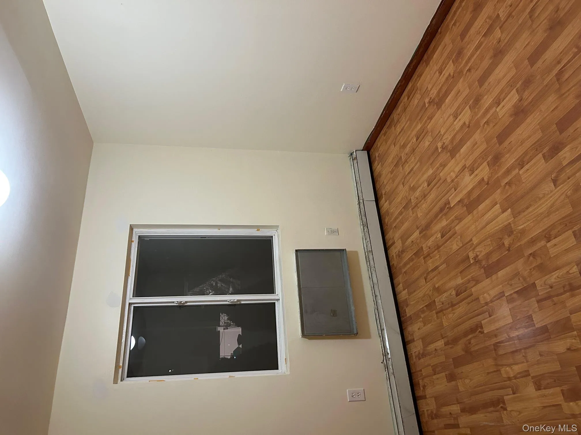 Empty room with baseboard heating and wood finished floors Empty room with baseboard heating and wood finished floors